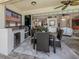 Outdoor kitchen and patio with stainless steel grill, seating, and lush landscaping at 162 Treviso Ct, North Venice, FL 34275