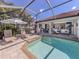 Screened lanai showcases a private pool with ample seating for outdoor relaxation and entertaining at 162 Treviso Ct, North Venice, FL 34275