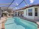 Screened pool with a seating area and an outdoor kitchen are steps from indoor living at 162 Treviso Ct, North Venice, FL 34275