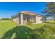 View of home's rear and backyard, including lanai area and green lawn at 17370 Cape Horn Blvd, Punta Gorda, FL 33955