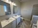 This bathroom features double sinks with white cabinets and modern fixtures at 17370 Cape Horn Blvd, Punta Gorda, FL 33955