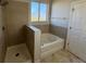 Well-lit bathroom features a tub, a separate shower, and a bright window at 17370 Cape Horn Blvd, Punta Gorda, FL 33955