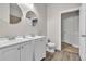 Bathroom featuring double sink vanity with white cabinets, modern fixtures and tile flooring at 17370 Cape Horn Blvd, Punta Gorda, FL 33955