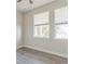This bedroom features modern gray flooring, neutral walls, and two sunny windows at 17370 Cape Horn Blvd, Punta Gorda, FL 33955