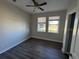 Bright bedroom boasts hardwood floors and natural light through two windows at 17370 Cape Horn Blvd, Punta Gorda, FL 33955