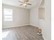 Bedroom features wood-look flooring, ceiling fan, neutral paint, and window at 17370 Cape Horn Blvd, Punta Gorda, FL 33955
