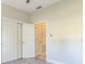 Bright bedroom features wood-look flooring, ceiling fan, and a large closet at 17370 Cape Horn Blvd, Punta Gorda, FL 33955
