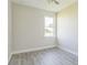 This bedroom features modern gray flooring, neutral walls, and a sunny window at 17370 Cape Horn Blvd, Punta Gorda, FL 33955