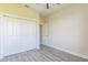 Bright bedroom features wood-look flooring, ceiling fan, and a large closet at 17370 Cape Horn Blvd, Punta Gorda, FL 33955