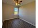 Bedroom boasts hardwood floors, neutral paint, ceiling fan, and natural light at 17370 Cape Horn Blvd, Punta Gorda, FL 33955