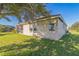 Rear view of the home with screened lanai and grassy backyard at 17370 Cape Horn Blvd, Punta Gorda, FL 33955