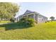 Well-maintained single-story home with landscaped front yard and healthy green grass at 17370 Cape Horn Blvd, Punta Gorda, FL 33955