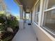 Home's front porch featuring gray flooring, neutral walls and manicured greenery at 17370 Cape Horn Blvd, Punta Gorda, FL 33955