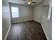 Living room features a modern ceiling fan, gray laminate flooring, and lots of light at 17370 Cape Horn Blvd, Punta Gorda, FL 33955