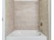 Tiled shower and tub combo with a shower head and silver fixtures at 17370 Cape Horn Blvd, Punta Gorda, FL 33955