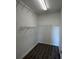 Walk-in closet with white wire shelving and laminate flooring at 17370 Cape Horn Blvd, Punta Gorda, FL 33955