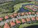 Aerial view of a neighborhood featuring red tile roofs, and proximity to golf course and lakes at 174 Treviso Ct, North Venice, FL 34275