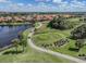 Scenic aerial view of golf course with cart paths and serene water features at 174 Treviso Ct, North Venice, FL 34275