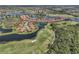 Extensive aerial view showcasing a golf course, lakes and community at 174 Treviso Ct, North Venice, FL 34275