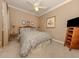 Cozy bedroom with natural light, a ceiling fan, and comfortable furnishings at 174 Treviso Ct, North Venice, FL 34275