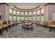 Beautiful dining area with large windows, cushioned seating, and elegant decor at 174 Treviso Ct, North Venice, FL 34275