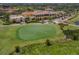 Scenic aerial of golf course and landscaping surrounding the large clubhouse at 174 Treviso Ct, North Venice, FL 34275