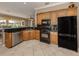 Efficient kitchen design with stainless steel appliances, granite countertops, and ample cabinet space at 174 Treviso Ct, North Venice, FL 34275