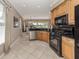 Well-lit kitchen featuring stainless steel appliances, granite countertops, and scenic outdoor views at 174 Treviso Ct, North Venice, FL 34275