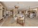 Open-concept living room and dining area with a ceiling fan and neutral tones, perfect for entertaining at 174 Treviso Ct, North Venice, FL 34275