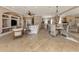 Bright and airy living room with tile flooring, built-in shelving, and seamless access to the dining area at 174 Treviso Ct, North Venice, FL 34275