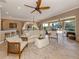 Spacious living room features tile floors, neutral decor, and sliding glass doors leading to a screened lanai at 174 Treviso Ct, North Venice, FL 34275