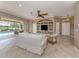 Spacious living room with a pool view, built-in shelving, neutral colors, and lots of light at 174 Treviso Ct, North Venice, FL 34275