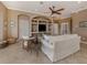 Inviting living room featuring a ceiling fan, built-in shelving, and neutral furnishings for relaxation at 174 Treviso Ct, North Venice, FL 34275