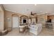 Comfortable living room with built-in shelving, white sofa, ceiling fan, and neutral color palette at 174 Treviso Ct, North Venice, FL 34275