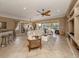 Comfortable living room with tile flooring, a ceiling fan, and views of the dining area and screened-in patio at 174 Treviso Ct, North Venice, FL 34275