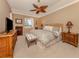 Comfortable main bedroom featuring a ceiling fan, natural light, and coordinated furnishings at 174 Treviso Ct, North Venice, FL 34275