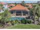 Inviting pool with screen enclosure, lounge chairs, and manicured landscaping at 174 Treviso Ct, North Venice, FL 34275