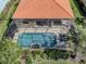 Aerial shot of the screened-in pool and lanai surrounded by lush landscaping at 174 Treviso Ct, North Venice, FL 34275