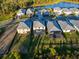 New construction homes with screened in lanais and well-maintained landscaping in this aerial view of the community at 17449 Luminous Ave, Venice, FL 34293