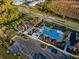 Aerial view of community pool and playground with ample parking and lush landscaping at 17449 Luminous Ave, Venice, FL 34293