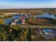 A stunning aerial view showcases the community pool and the surrounding new construction neighborhood at 17449 Luminous Ave, Venice, FL 34293