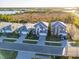 Aerial view of new construction homes, manicured lawns and brick paved driveways in a quiet neighborhood at 17449 Luminous Ave, Venice, FL 34293