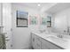 Bright bathroom with double vanity, mirror and cute elephant prints at 17449 Luminous Ave, Venice, FL 34293