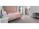 Bright bedroom with desk and a light pink themed bed at 17449 Luminous Ave, Venice, FL 34293