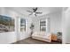 Cozy bedroom with a ceiling fan, two windows, and comfortable seating at 17449 Luminous Ave, Venice, FL 34293