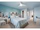 Bright blue bedroom featuring vanity, mural, and cozy furnishings at 17449 Luminous Ave, Venice, FL 34293