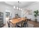 Bright dining room featuring a modern chandelier, table with seating, and stylish decor at 17449 Luminous Ave, Venice, FL 34293