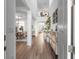 Bright, open entryway with wood floors, staircase, and view into the living spaces at 17449 Luminous Ave, Venice, FL 34293