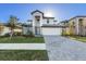 Beautiful two-story home featuring a two-car garage, well-manicured lawn, and neutral-colored accents at 17449 Luminous Ave, Venice, FL 34293