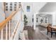 Bright and airy foyer with a staircase, bench, and an open view to the living area at 17449 Luminous Ave, Venice, FL 34293